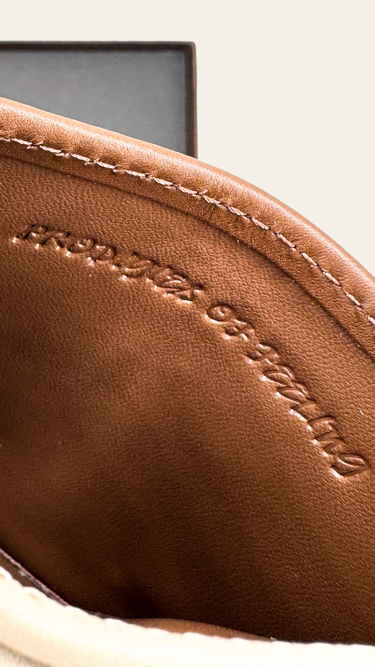Close-up of a brown leather product with stitching detail 
