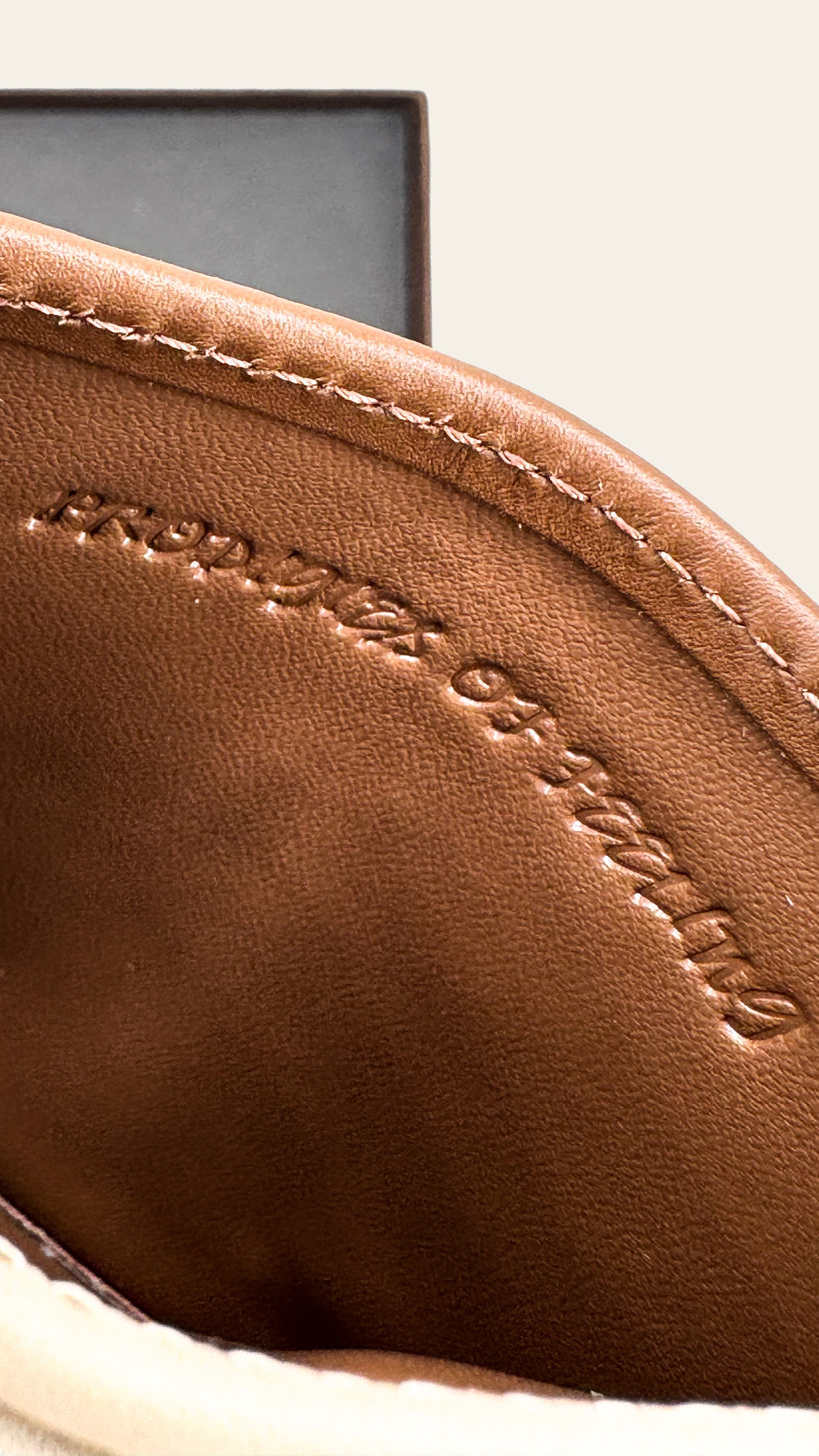 Close-up of a brown leather product with stitching detail 